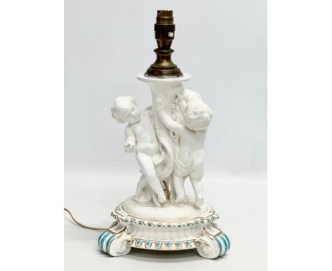 A Late 19th Century Italian 3 putti table lamp, with a serpentine style column on a 2 tier gilt and turquoise base, raised on