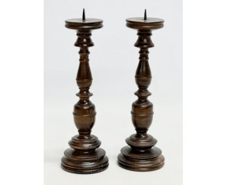 A pair of vintage turned beech candlesticks. 29cm