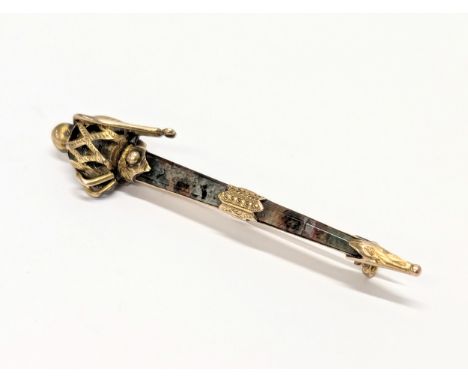 A vintage ornate gold plated brooch in the form of a sword. 5.5cm