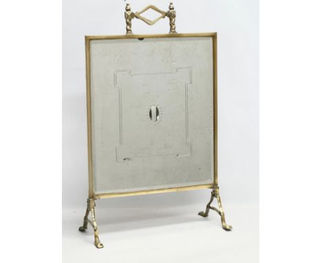 An Edwardian brass framed firescreen with bevelled glass panel. 46x75cm