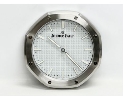 An Audemars Piguet adverting wall clock. 33cm