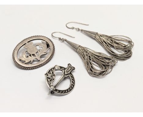 A quantity of silver including a pair of earrings, a Celtic brooch, and a Scottish Thistle brooch