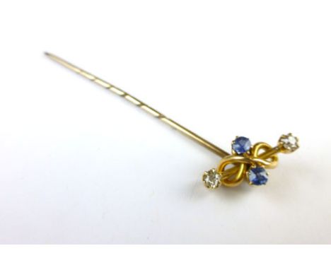 A 15ct yellow gold stick in set two small diamonds and two ale blue sapphires within a knotted setting 