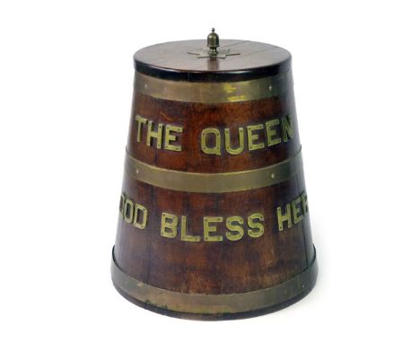 A ship's oak rum barrel of tapering form with applied brass inscription 'The Queen God Bless Her' and an acorn finial, h. 53 