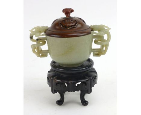 A 19th century Chinese jade libation cup with a carved hardwood foliate cover, decorated with flamed pearl carvings and two h