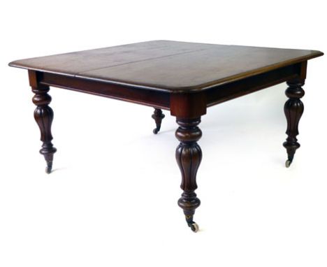 A Victorian mahogany telescopic extending dining table, with two fitted leaves, the moulded top over turned and bulbous reede