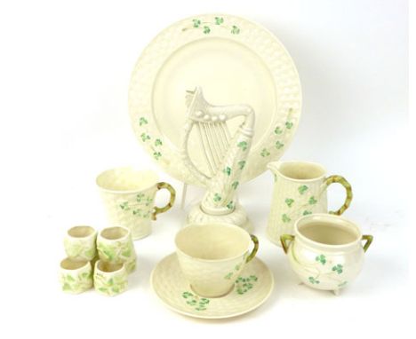 A quantity of Belleek tablewares, each decorated with clover leaves on a white trellis ground, together with a matching ornam