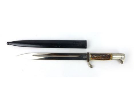 A Second World War 1936 patent German Nazi bayonet with elk horn grip, marked Solingen with the scabbard, blade l. 24.5 cm  