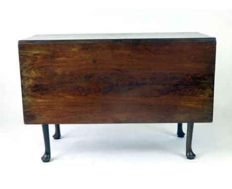 A George II mahogany drop leaf dining table, the figured mahogany top above the single gate action with rounded legs on pad f