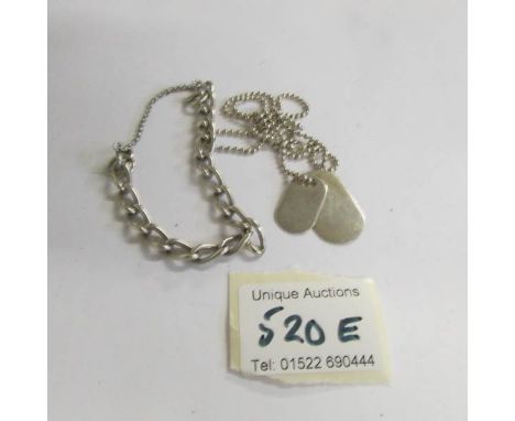 A silver dog tag necklace and a silver bracelet.