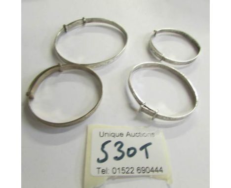 4 silver bangles.