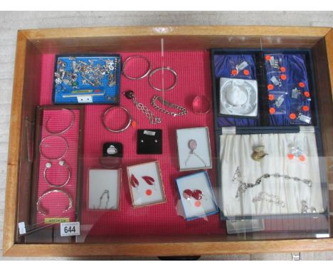 A display case of silver bangles, charms, earrings etc., (this lot is buyer collect only). ****Condition report**** Outside s