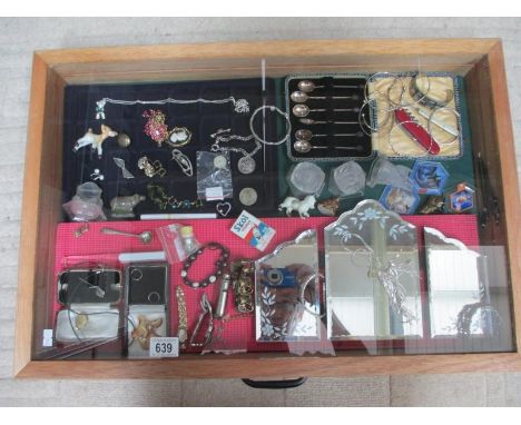 A display case containing a mixed lot of jewellery including some silver, a cased set of spoons etc., (this lot is buyer coll