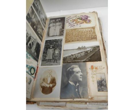 A large and voluminous Victorian and Edwardian Album containing postcards,cigarette cards,scraps and picture-greetings, cutti