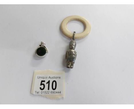 An early 20th century childs silver rattle with teething ring together with a silver fob dated Birmingham 1881 set with a blo