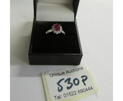 An 18ct gold ruby and diamond ring (Ruby 125, diamond 70pt) size M half.