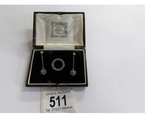 A pair of early 20th century paste set ear pendants and a matching brooch in silver and in original case.