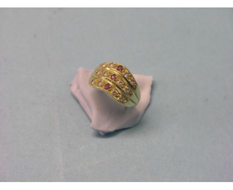 A 14ct. gold dress ring, set small clear and red stones