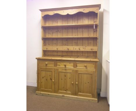 A large, waxed pine dresser, three-shelf plate rack with five spice drawers, panelled cupboard base with three drawers, 4ft. 