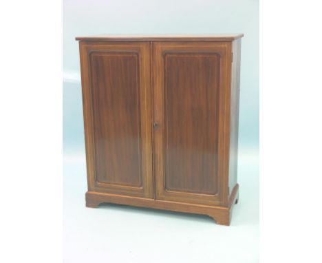 An Edwardian inlaid mahogany bookcase, pair of panelled doors enclosing two adjustable shelves, bracket feet, 3ft. 