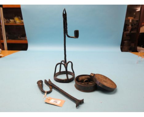 A 19th century tinplate tinder box, circular-shape with cover and striking iron, 4.25in. and two iron rush-light nips, talles