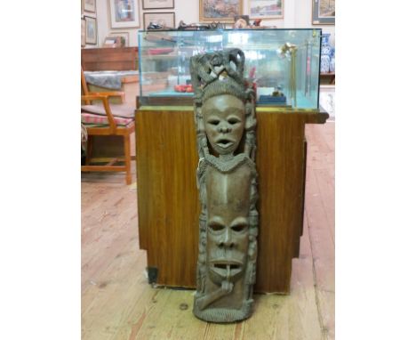 An African wood carving, two portrait masks and figures, 37in. 