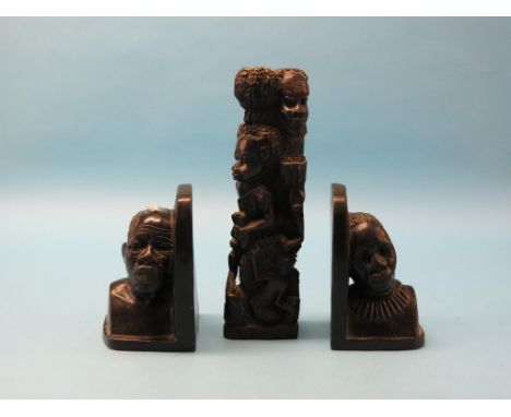 African book-ends, each a carved stone portrait bust, 8in. together with an African figure group wood carving, 14in. 