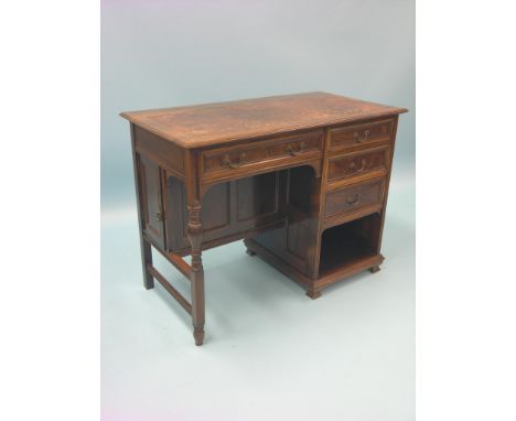 A small Victorian rosewood desk, inset leather top with concealed pen recess, kneehole arrangement of four drawers and open c
