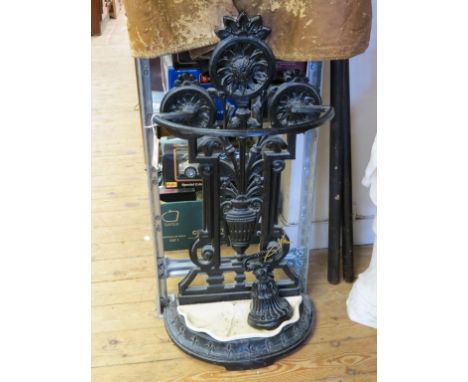 A Victorian cast iron stick-stand, elaborately cast and a similar door-stop 