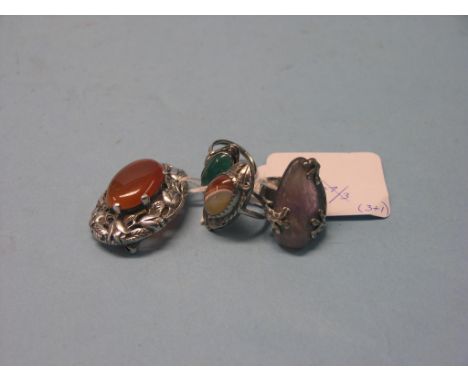 A silver dress ring, with inset amethyst-type stone, two white metal dress rings with inset stones and an oval silver leaf br