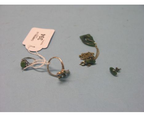 A jade pendant, pair of jade ear-rings and two white metal rings with jade mounts 