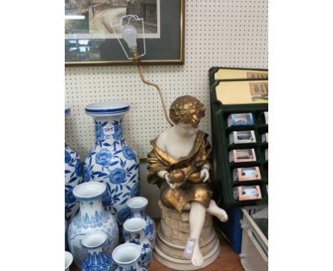 A large figural floor lamp, Orfanello, melancholy seated youth, with shade, 40in. together with an oval, brass-framed service
