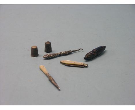 A silver button hook, folding knife with silver blade, a silver thimble, bodkin in sheath, etc. 6 items total 