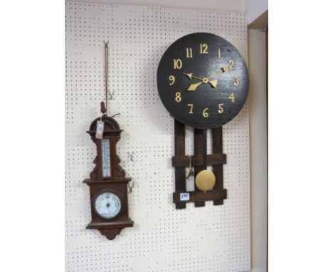 An Art Nouveau dark oak wall clock, with 16in. wood dial, together with a late Victorian oak aneroid barometer, 22in. and two