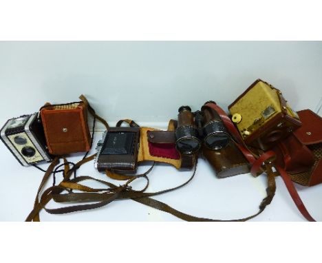 A pair of Dolland binoculars with case, a Nettar camera, a Brownie Six-20 camera and a Kodak Duaflex