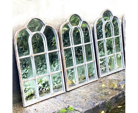 ARCHITECTURAL GARDEN MIRRORS, a set of three, with metal frames, 60cm H x 39cm. (3) 
