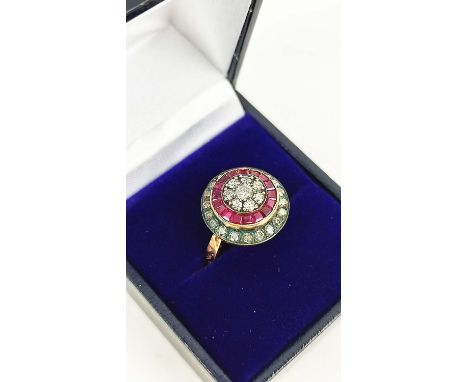 AN 8CT ROSE GOLD RUBY AND DIAMOND CLUSTER RING, with calibre cut rubies and round brilliant cut diamonds, hand carved shoulde