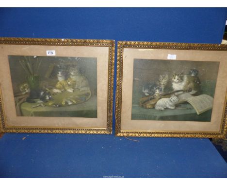 A pair of gilt framed prints of cats around a violin and cats on an artist's table, 2 1/2'' x 17 1/2''.