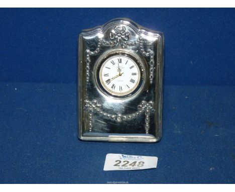 A Silver faced Easel Clock with raised swag decoration, Sheffield 1994, maker R. Carr, 3 1/2'' tall, working order.