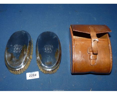 Two silver backed brushes with comb, in a leather case, Birmingham 1914 by James Dean &amp; Sons.