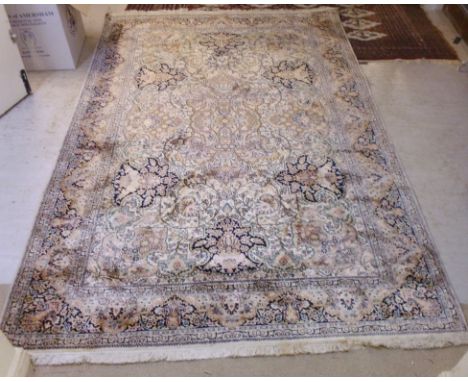 A Central Persian design rug with a central medallion and six palmettes on a cream coloured ground  107'' x 71'' 
