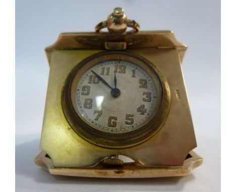 A 9ct gold square cased pocket size traveller's timepiece with decoratively cast and engine turned ornament, the movement fac