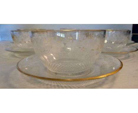 A set of six Georgian cut glass finger bowls and saucers, decorated with fruiting vine and gilding