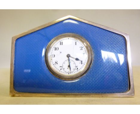 A silver and engine turned blue enamel, arched block cased timepiece; the Swiss made movement faced by a Roman dial with subs