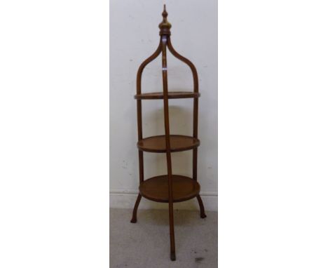 A late Victorian satinwood and floral painted cakestand, having a turned finial, over three dished tiers, raised on splayed, 