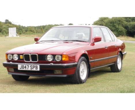 A BMW (E32) 730i, 2988cc automatic saloon car, in Calypso Red and trimmed in light silver leather with an electric sun roof a