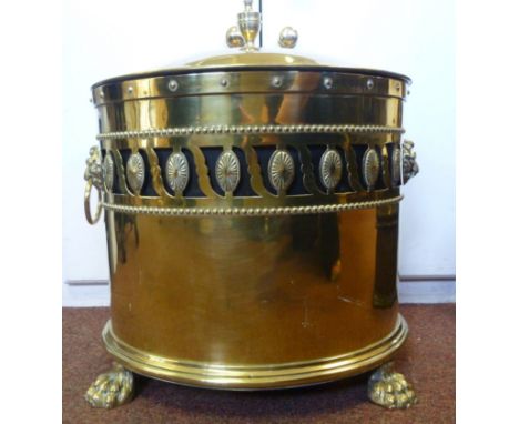 A Victorian brass oval coal bin, having straight sides, a decoratively pierced frieze, opposing lion mask ring handles, a dom