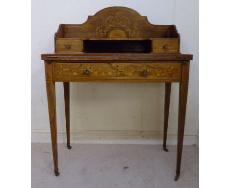 A late Victorian string inlaid rosewood and marquetry writing table, having a foldover top, enclosing a gilt tooled green hid