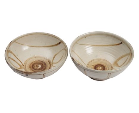 * Michael Cardew [1901-1983] a pair of stoneware bowls: of circular form with incised rings above the foot, the interior and 
