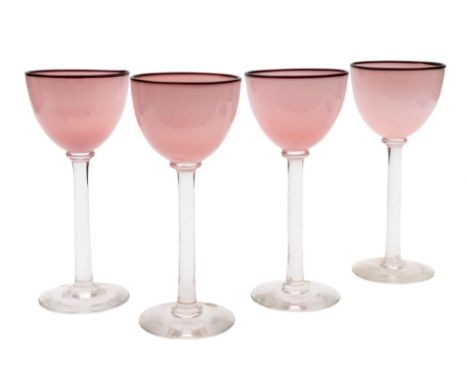 * Neil Wilkin [b. 1959] hand blown stem ware: comprising eight large goblets each with pink bowl and ruby rim, on a straight 